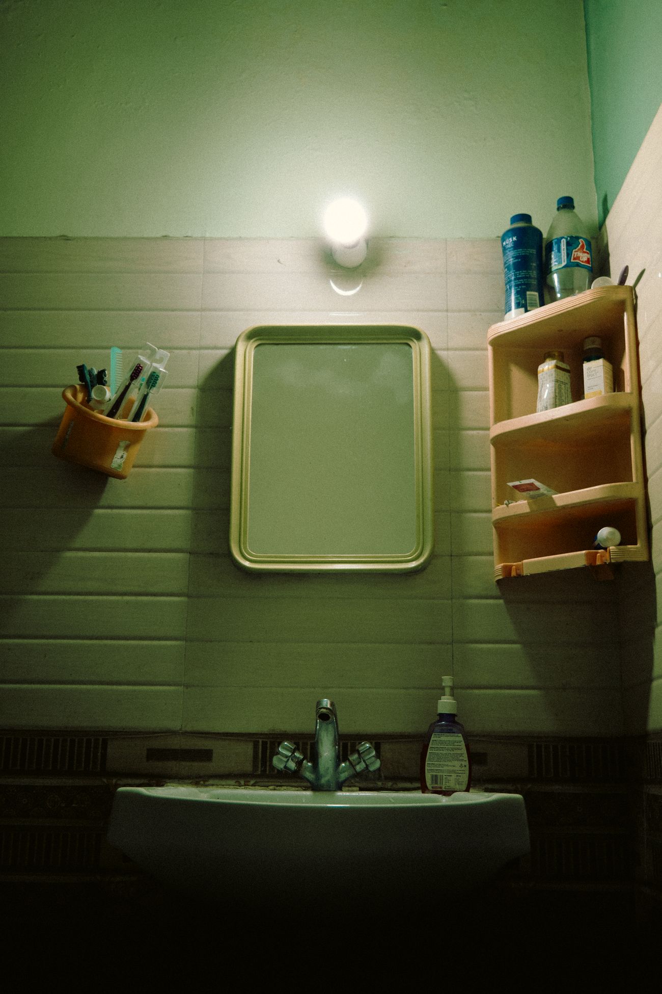 Bathroom sink, mirror, and toiletries