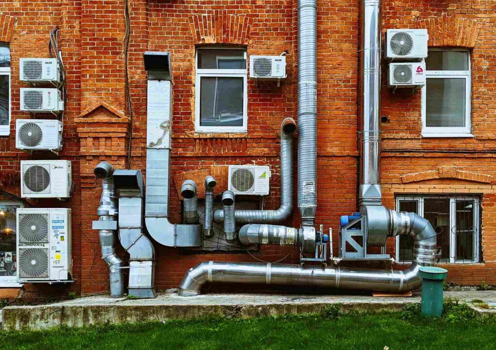 Brick building with HVAC ductwork and air conditioning units