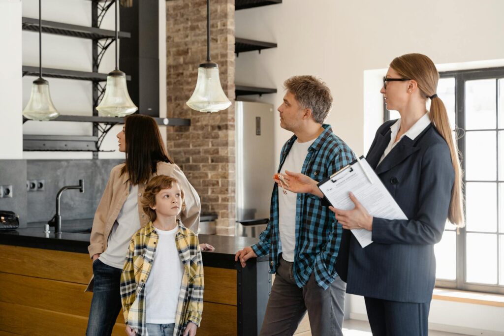 Family reviewing a home with a real estate agent during an inspection