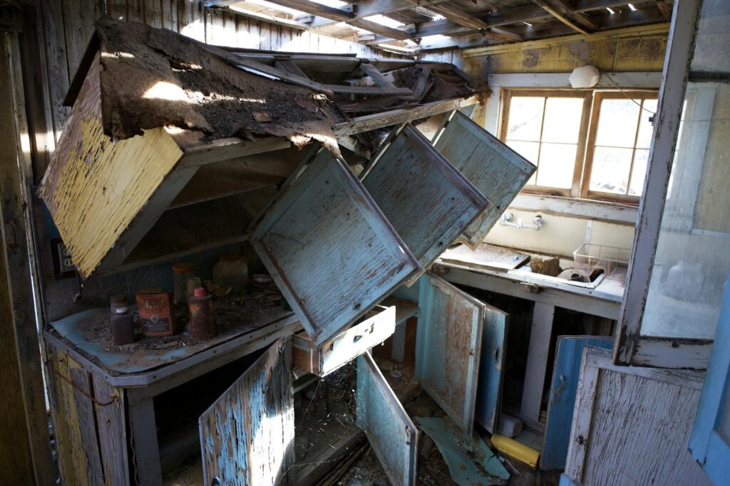 Collapsed kitchen cabinets in an abandoned house