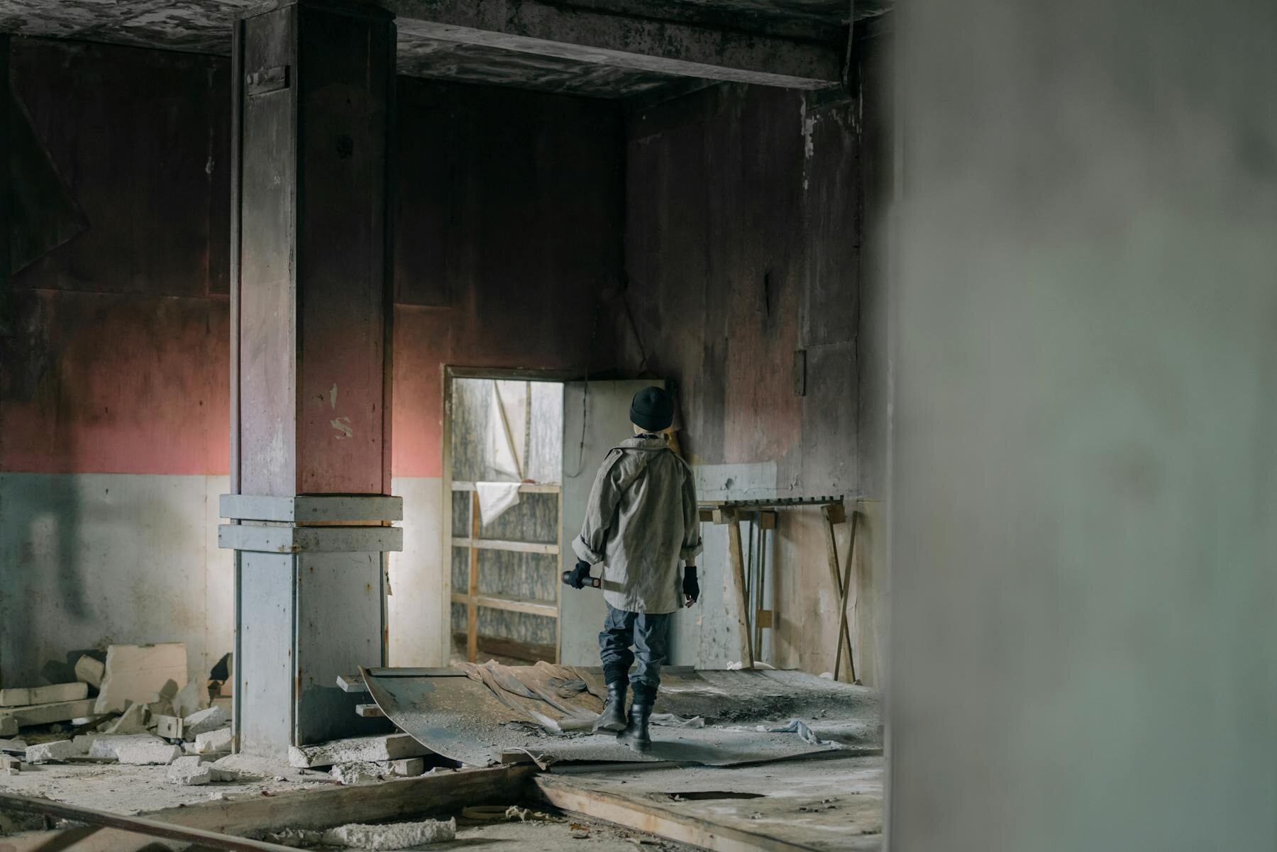 Person walking through damaged mold-filled building