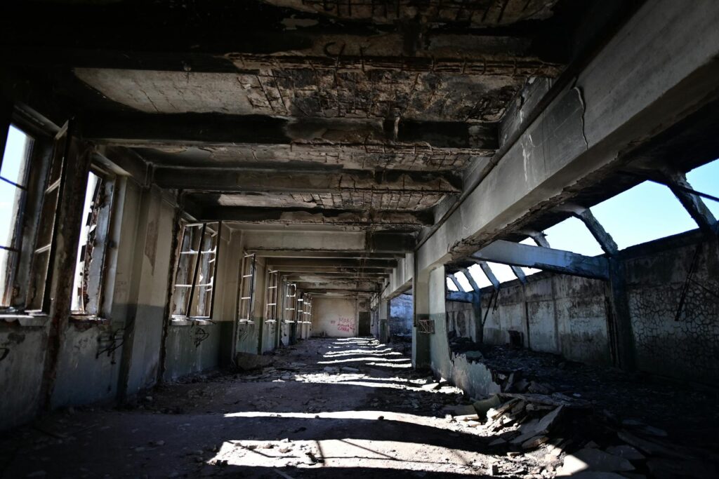Damaged commercial hallway with exposed ceiling