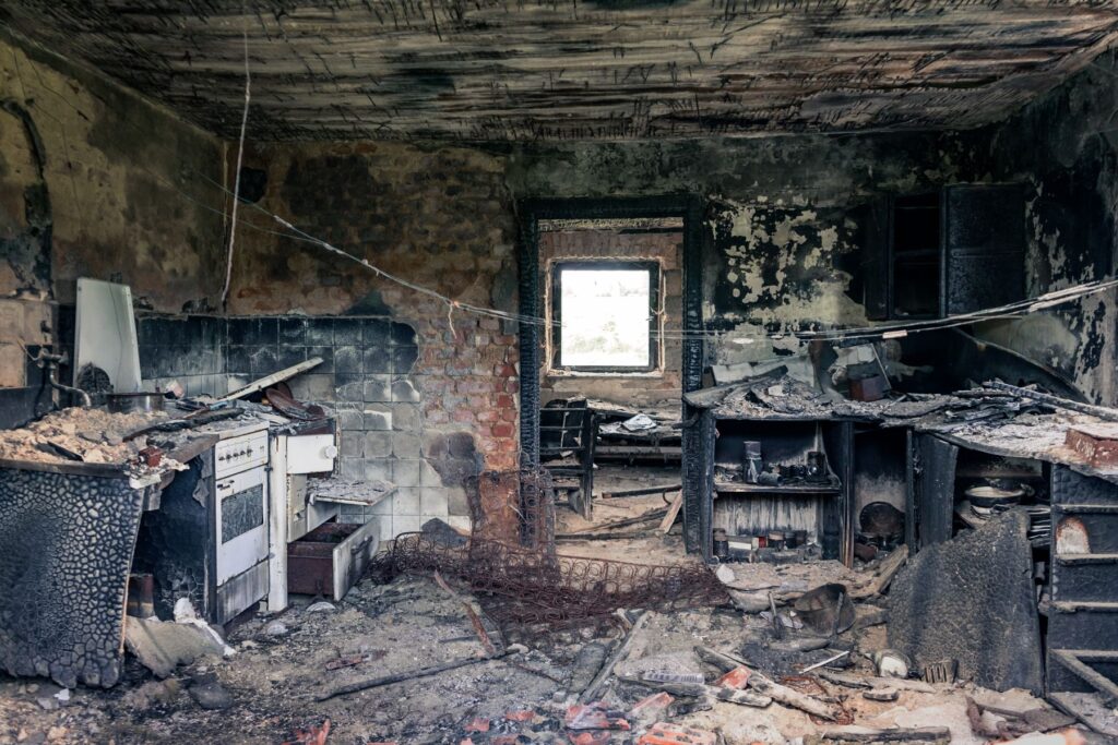 Burned kitchen interior with smoke and fire damage