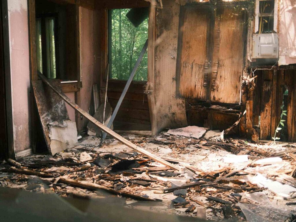 Burned interior room with debris and charred walls