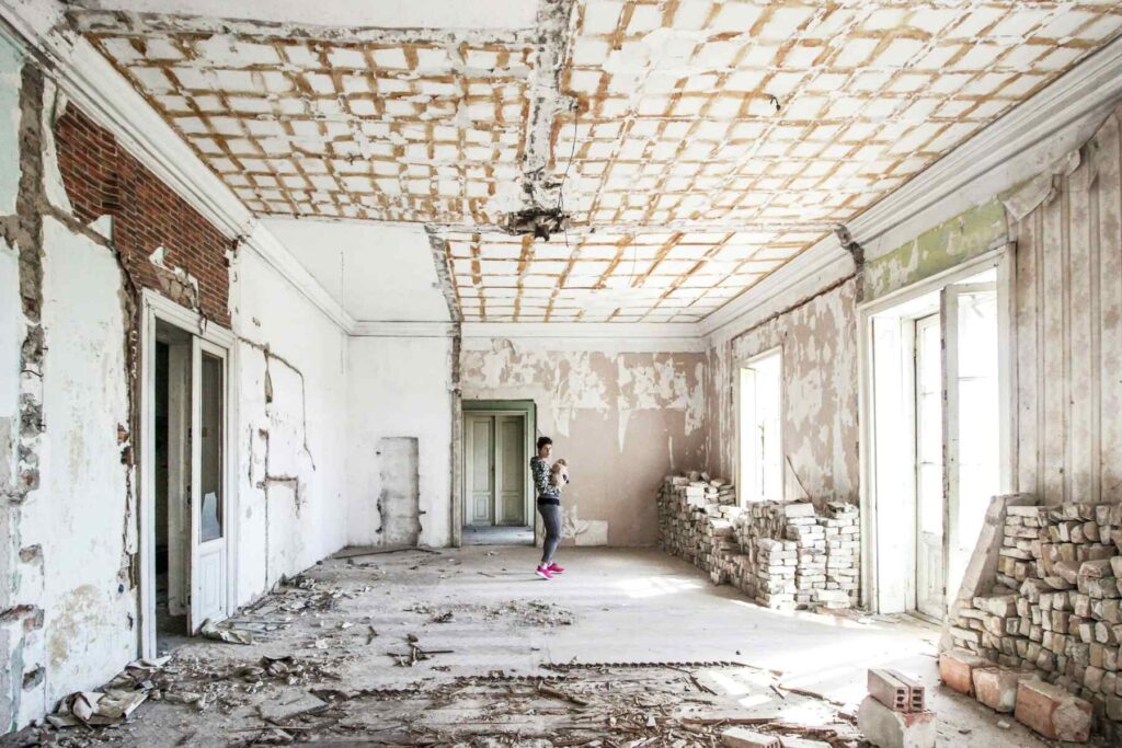Renovation site with exposed ceiling and worn walls