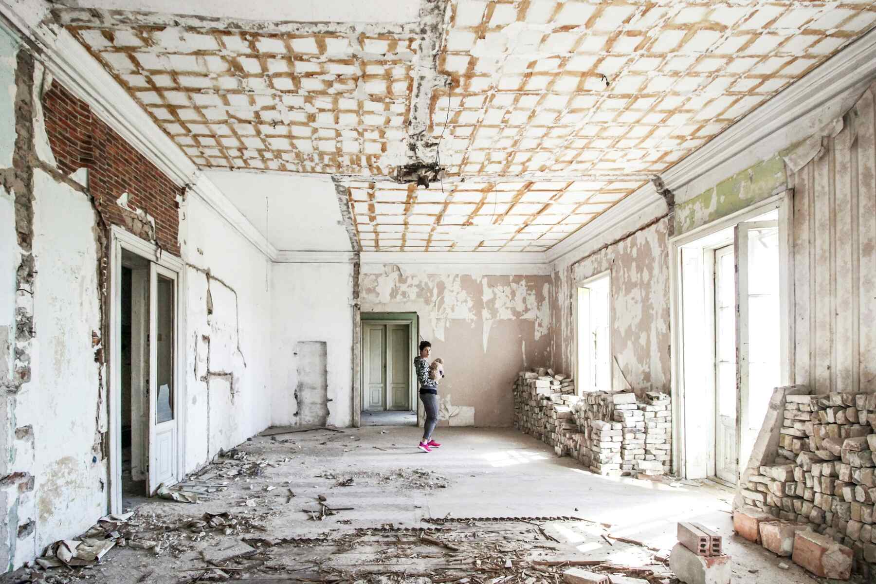 Renovation site with exposed ceiling and worn walls