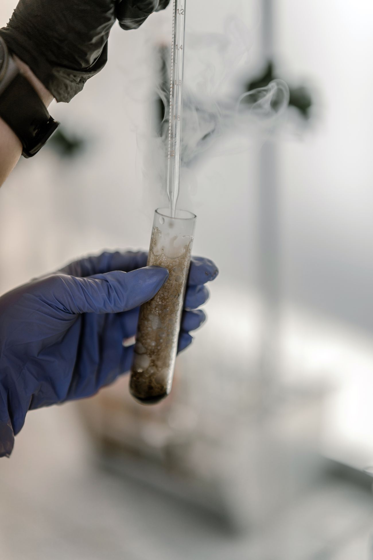 Technician analyzing a test tube during VOC laboratory testing