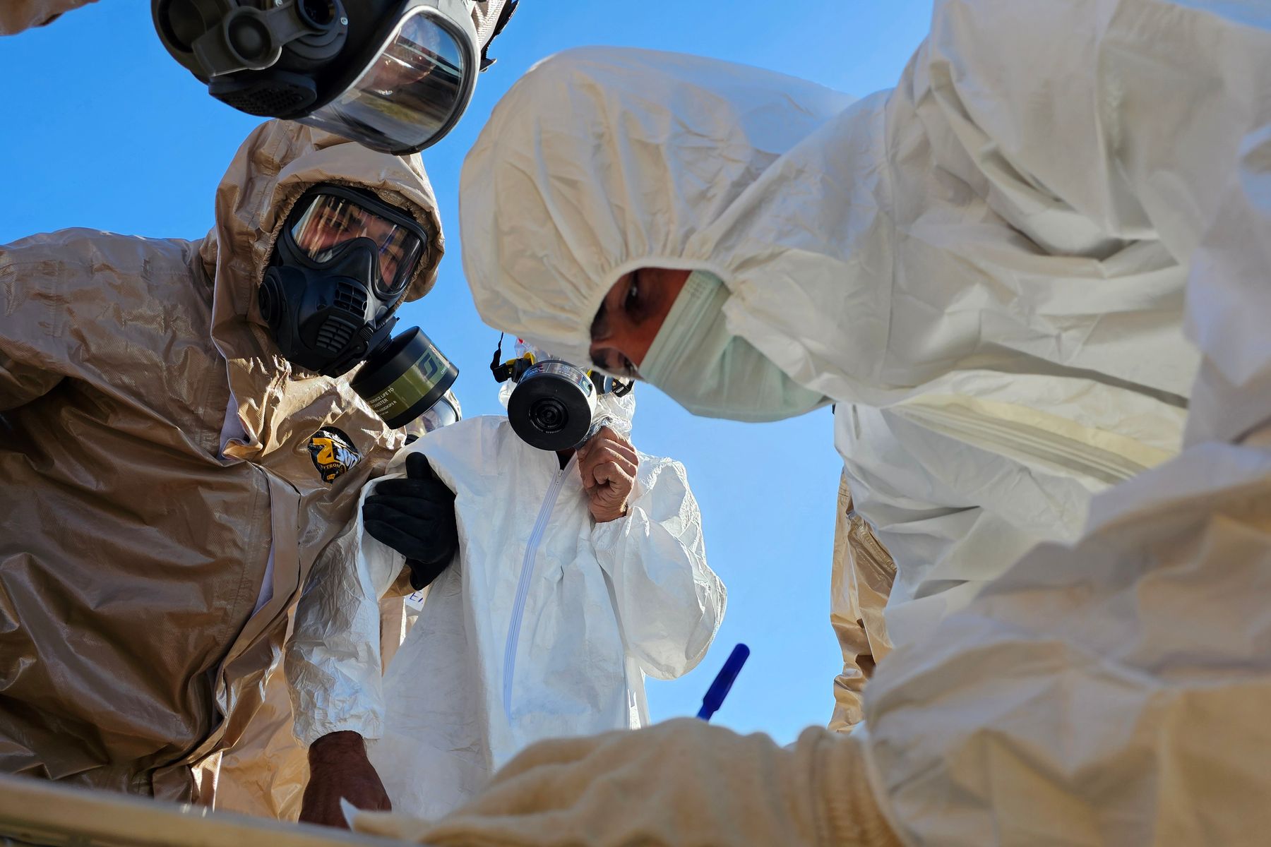 Hazardous materials team wearing protective suits and respirators during an inspection