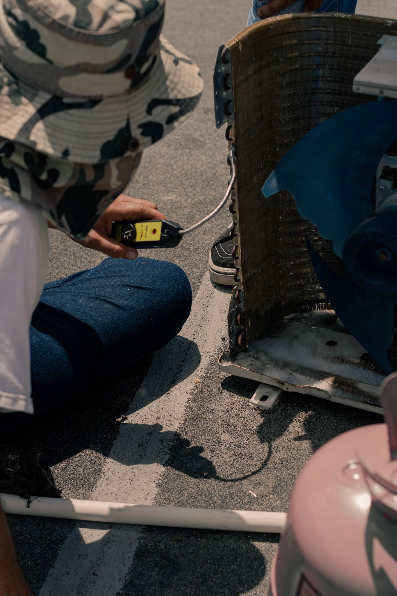 Technician testing an HVAC coil with an air quality meter