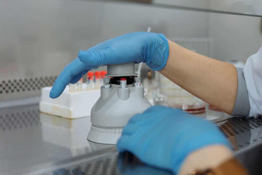 Lab technician handling test samples with protective gloves