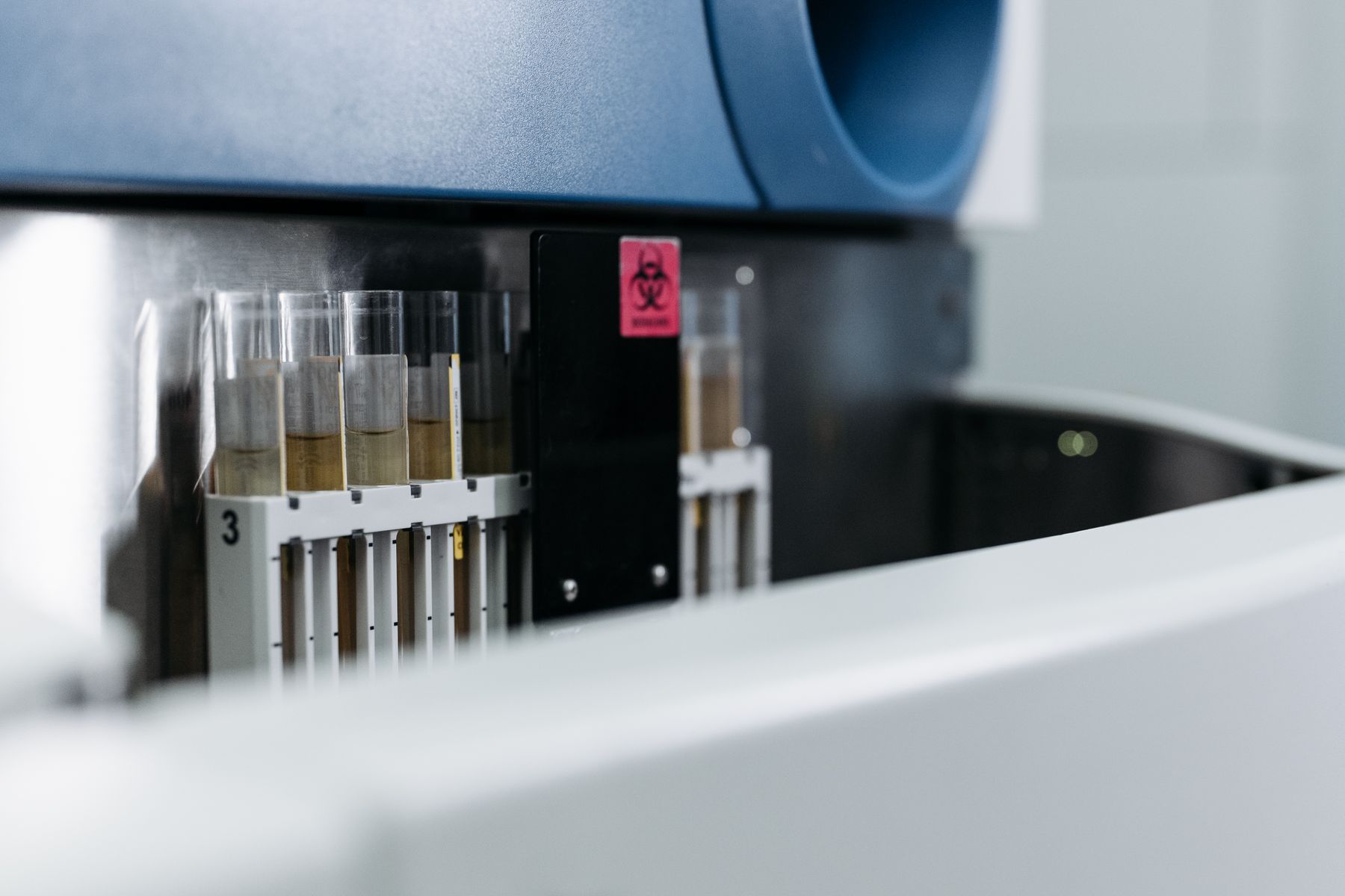 Laboratory test tubes arranged inside testing equipment