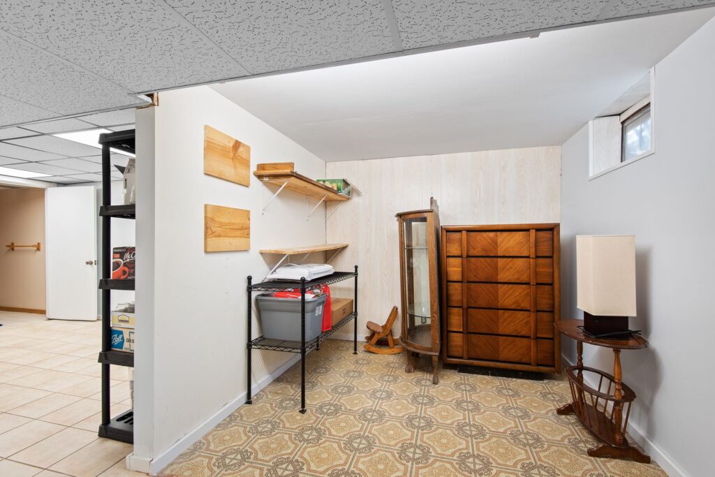 Finished basement with furniture and storage shelves