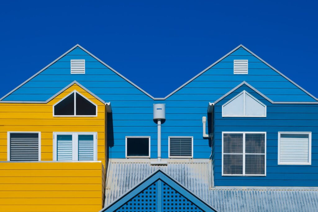 Bright blue and yellow residential building exteriors